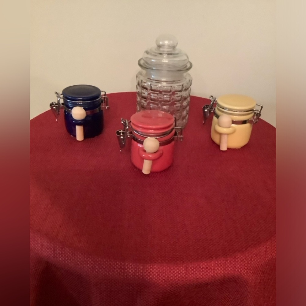 A set of storage jars 3 matching with wooden spoons & 1 larger all 4 with seals